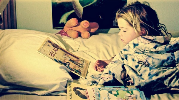 Med thumb girl reading in bed