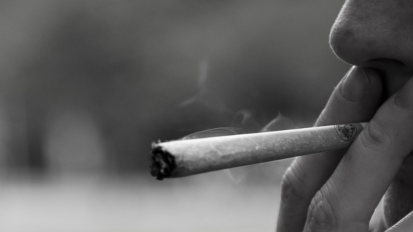 Med thumb smoking a joint